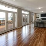 homeguide-spacious-living-room-with-hardwood-flooring-and-glass-doors